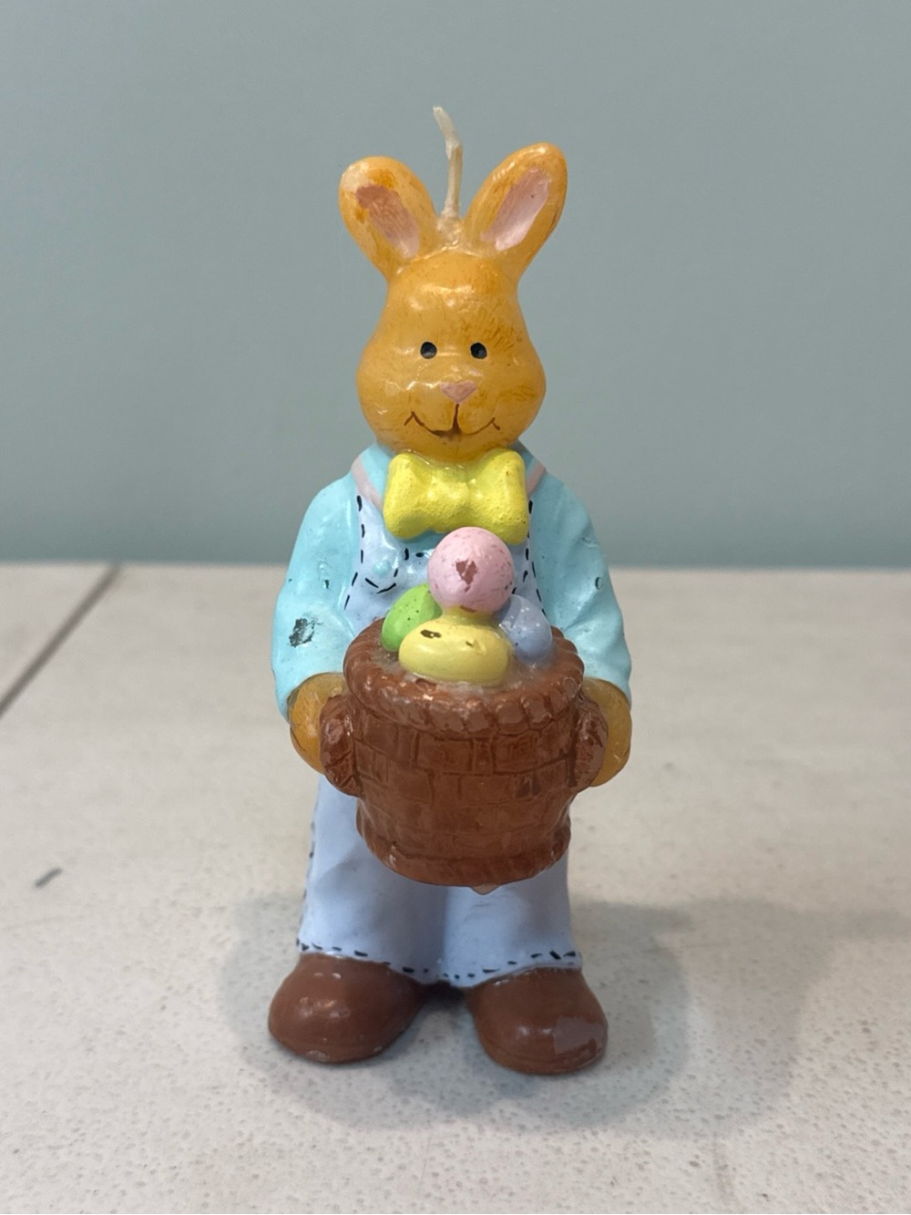 Adorable vintage easter bunny candle holding basket of eggs